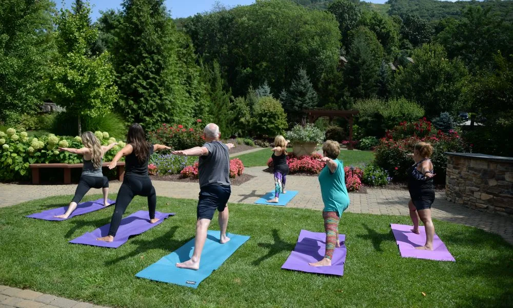 Group of people doing yoga outdoors.