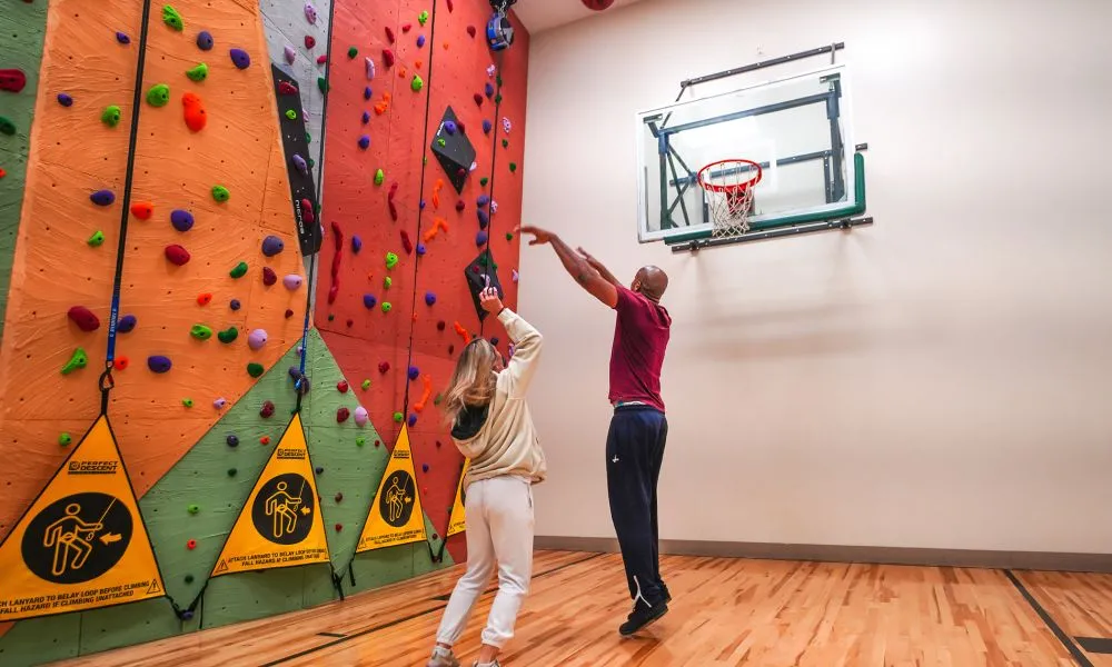 Two people playing basketball.