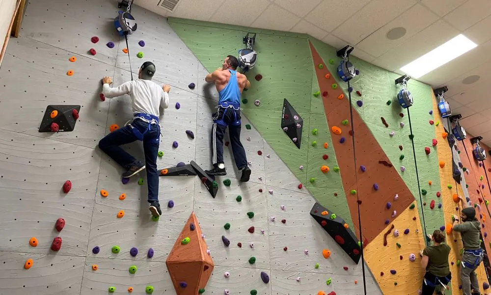 Two men rock climbing.