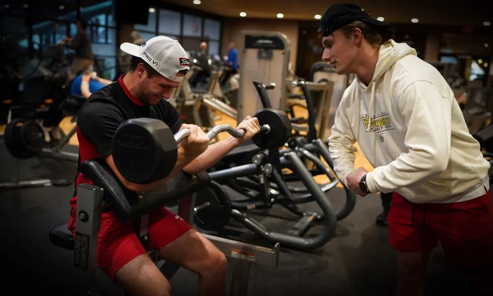 Personal training session where client is doing bicep curls. 