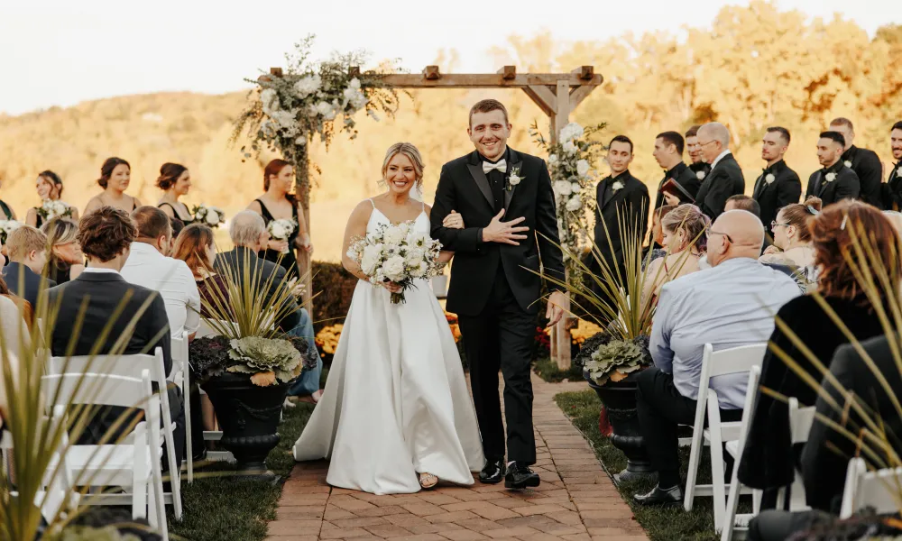 Bride and groom walk back down aisle after their Ballyowen Wedding Garden fall ceremony.