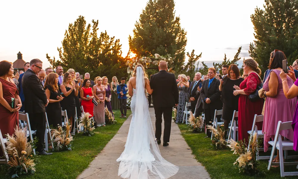 Bride walking down the aisle at Wedding Garden ceremony space at Crystal Springs Country Club. 