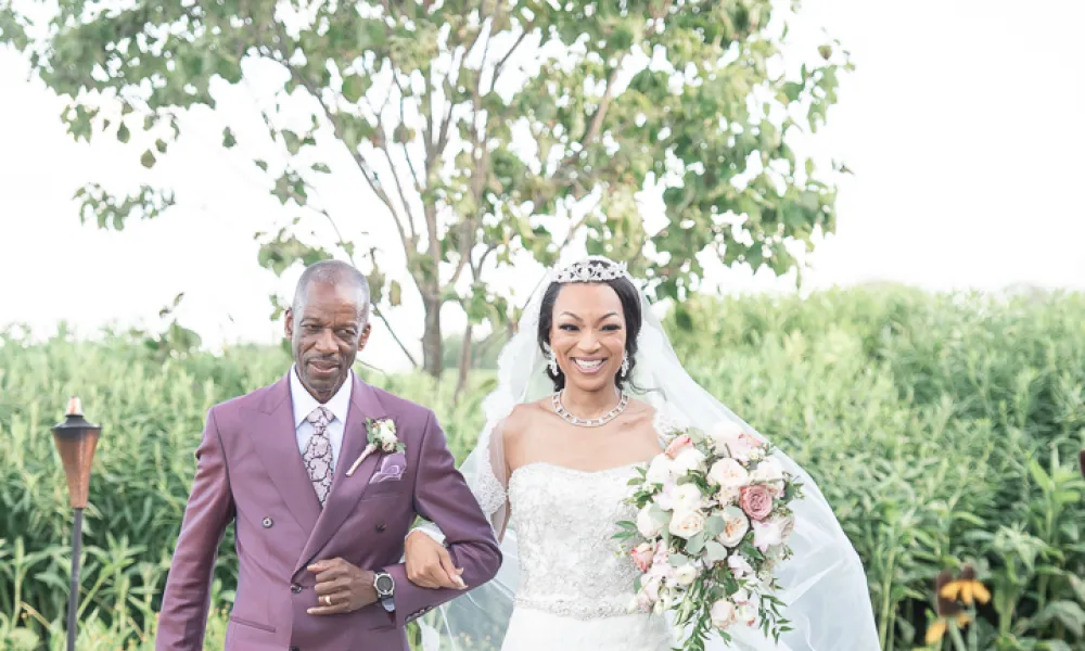 Bride walks down aisle with father during ceremony at Ballyowen Wedding Garden.