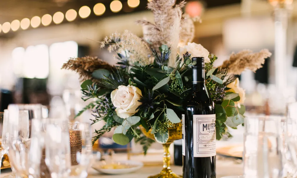 Flowers on table with wine during a Ballyowen Bailigh Bluff House wedding reception.