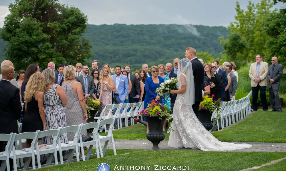 Bride walking down the aisle at Wedding Garden ceremony space at Crystal Springs Country Club. 