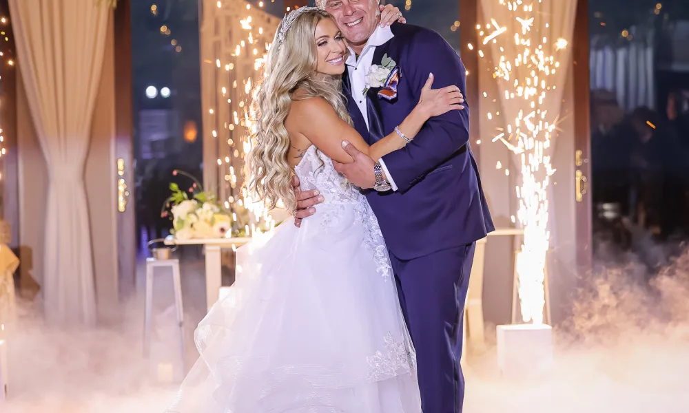 Couple hugging as they stand in fog on the dance floor during their Bailigh Bluff House wedding reception.