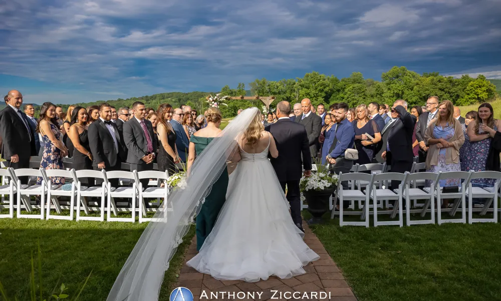 Bride walks down aisle with mother and father during her Ballyowen wedding garden ceremony. 