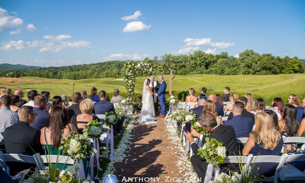 Bride and groom hold hand during their ceremony at Ballyowen Wedding Garden.