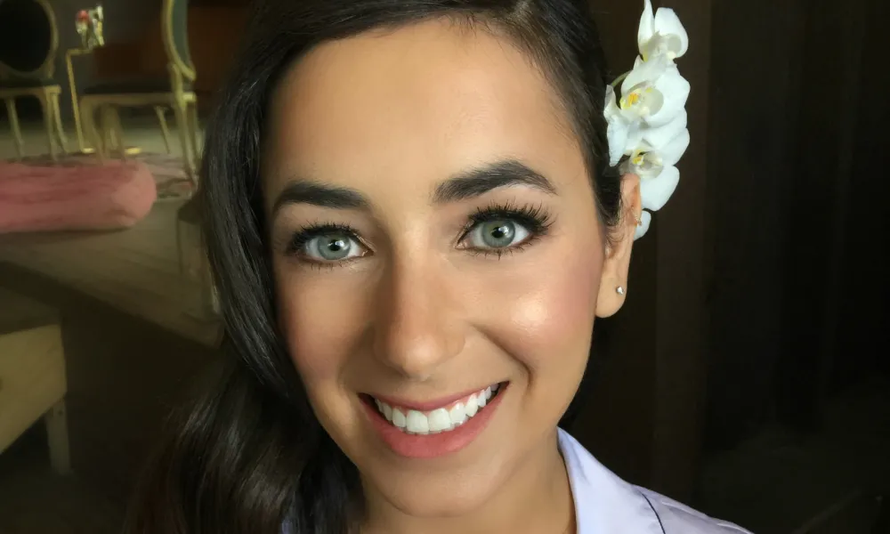 Brunette Woman with her hair curled to the side. 