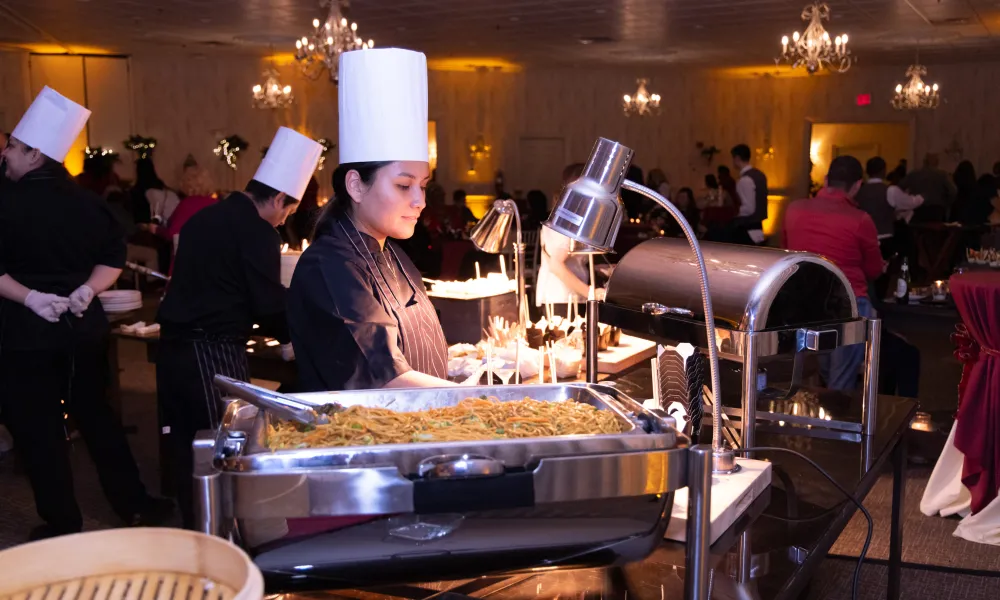 Chef distributing food in Diamond Cocktail Room. 