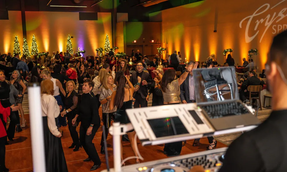 Guest dancing in Canyon Ballroom during Christmas wedding reception.