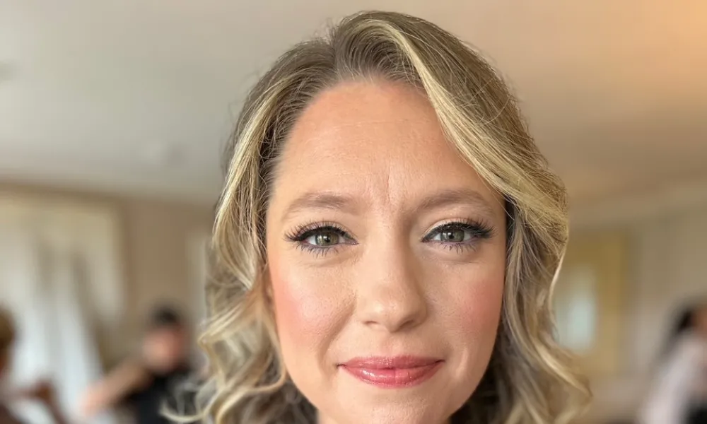 Woman with blonde curled hair. 