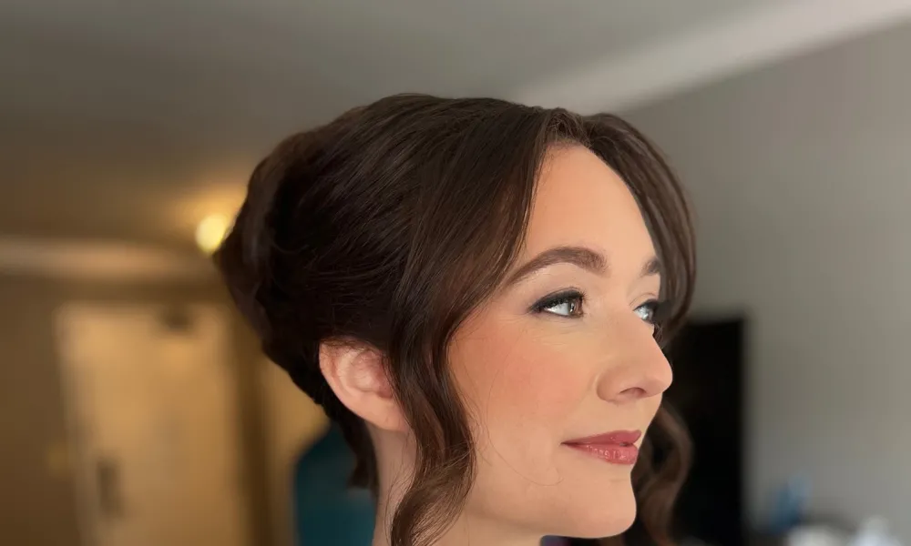 Side profile of woman with updo hairstyle. 