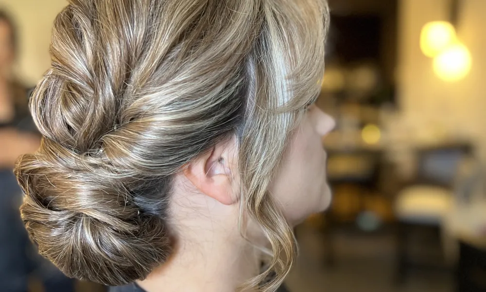 Side profile of woman with updo hairstyle. 