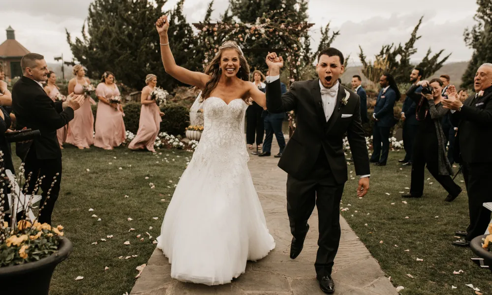 Bride and groom walk down aisle at Bride walking down the aisle at Wedding Garden ceremony space at Crystal Springs Country Club. 