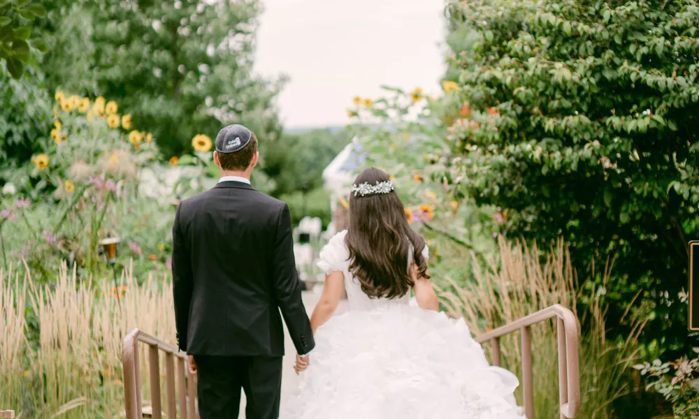 Bride and Groom holding hands. 