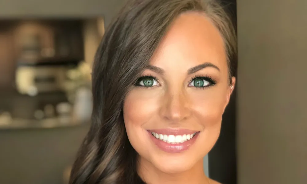 Brunette Woman with her hair curled to the side. 