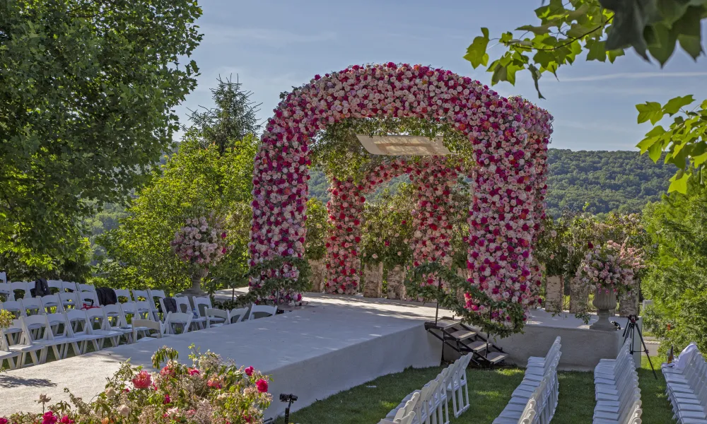 Floral arch of an array of pink colored flowers in the amphitheatre wedding ceremony venue.