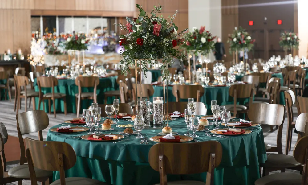 Round tables set up with green tablecloths for wedding reception in the Canyon Ballroom.