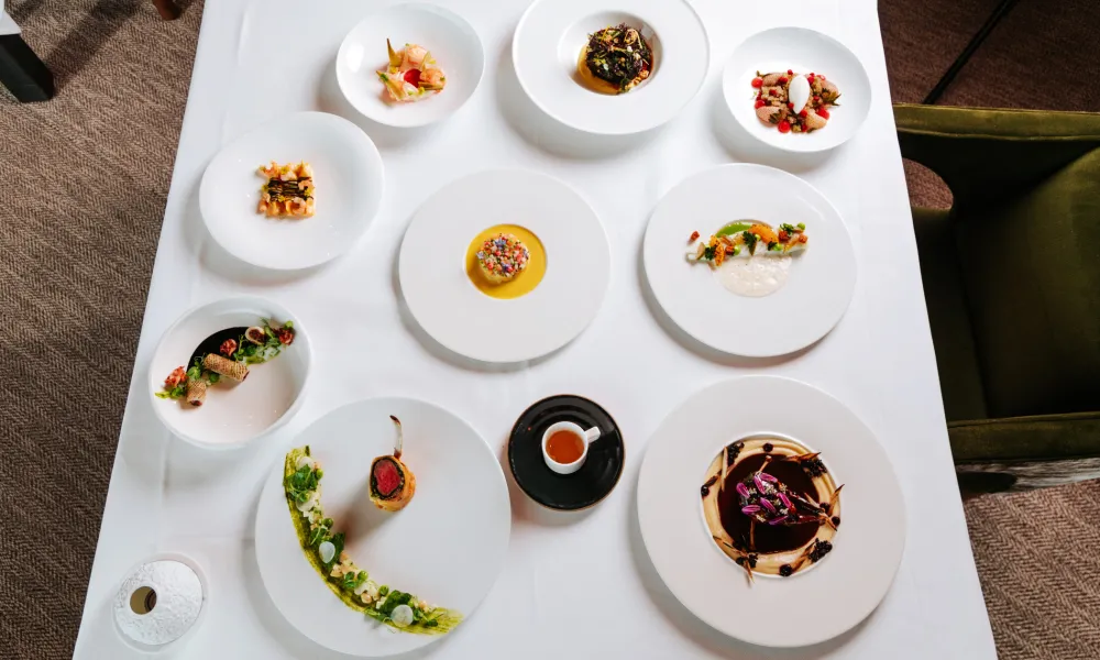 Array of Restaurant Latour food dishes displayed on white tablecloth.