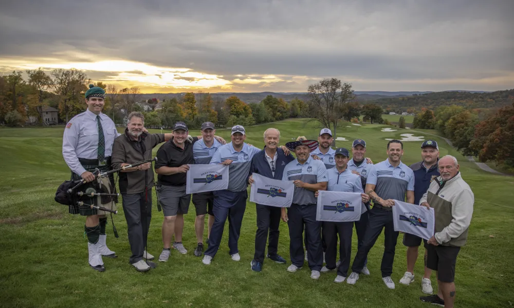 Ballyowen Law Enforcement Open golfers stand with Kelsey Grammer. 