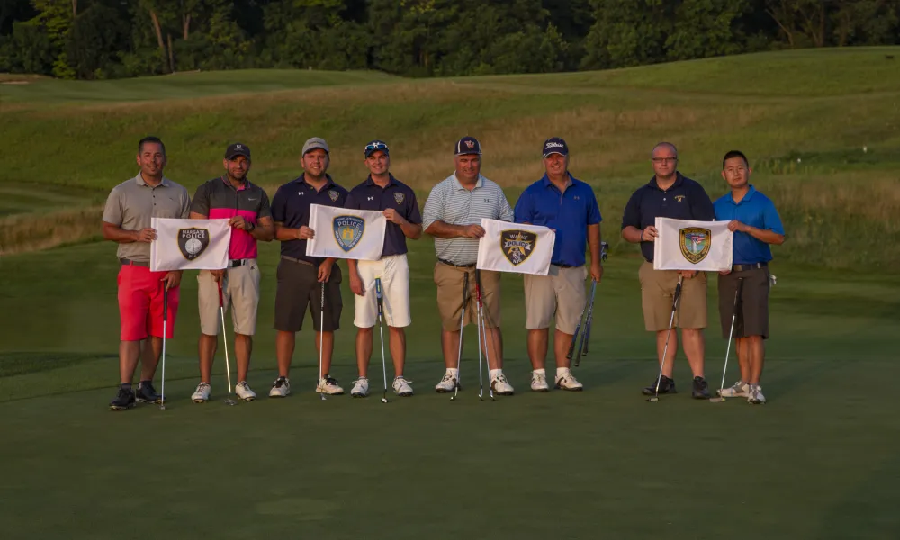 Ballyowen Law Enforcement Open golfers standing with police flags. 