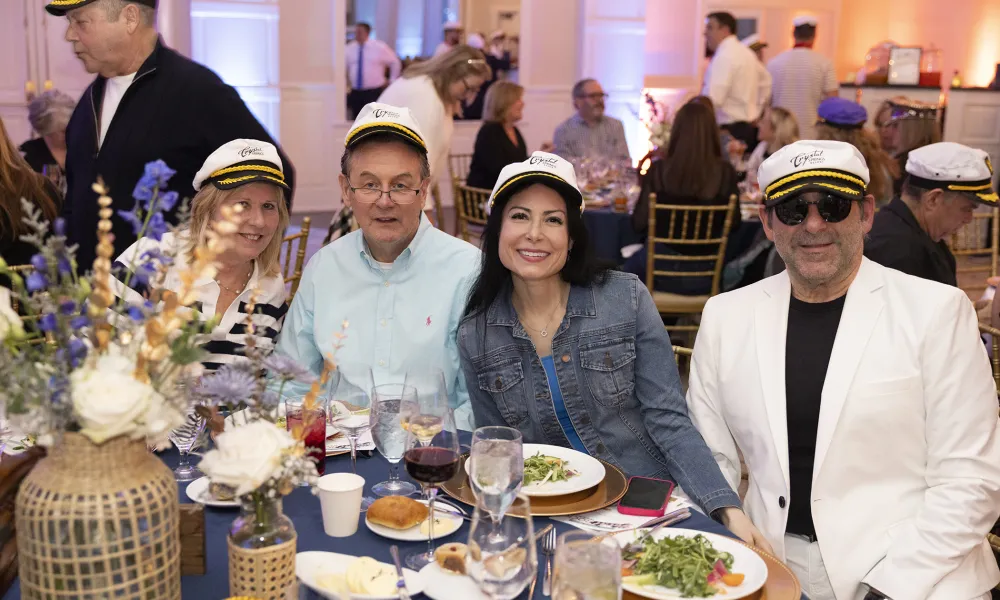 Group of friends sit together at Yacht Rock