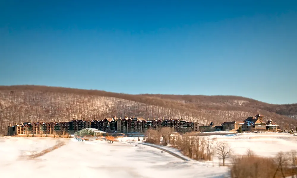 Distance exterior view of Grand Cascades Lodge in the winter