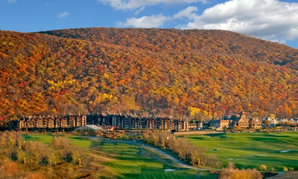 View of fall mountains behind Grand Cascades Lodge at Crystal Springs Resort in NJ