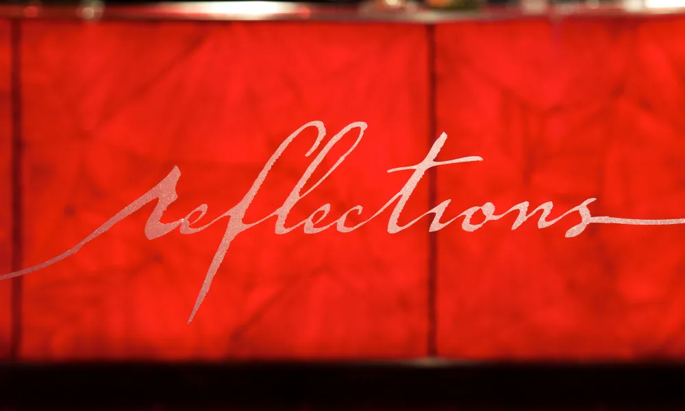 Reflections logo on glass door entrance.