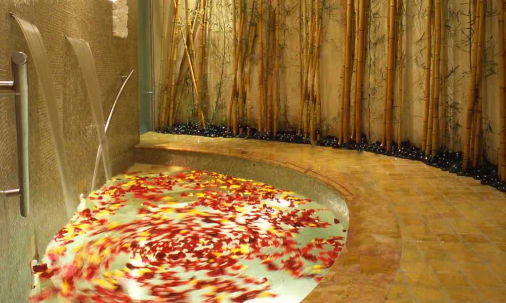 Hot tub at Elements Spa filled with flower petals.