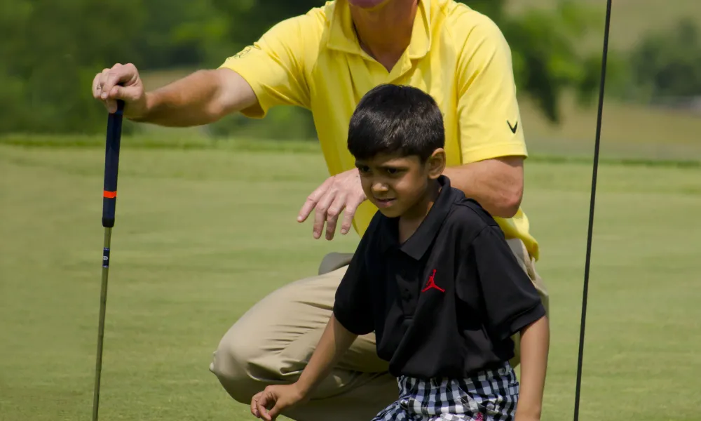 LeadBetter Golf Academy instructor teaching young boy to golf