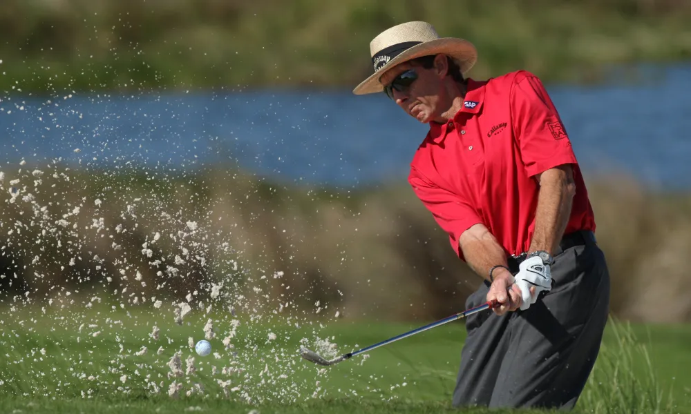 Man in red shirt golfing at Crystal Springs Resort