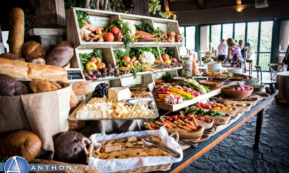 Cocktail hour table food displayCocktail hour table food display of breads, cheeses and more