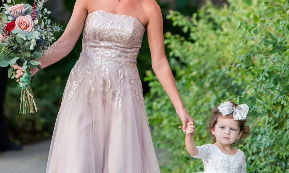 Beautiful bride walking with flower girl