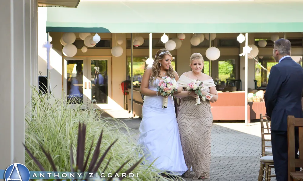 Bride walking down aisle with mother