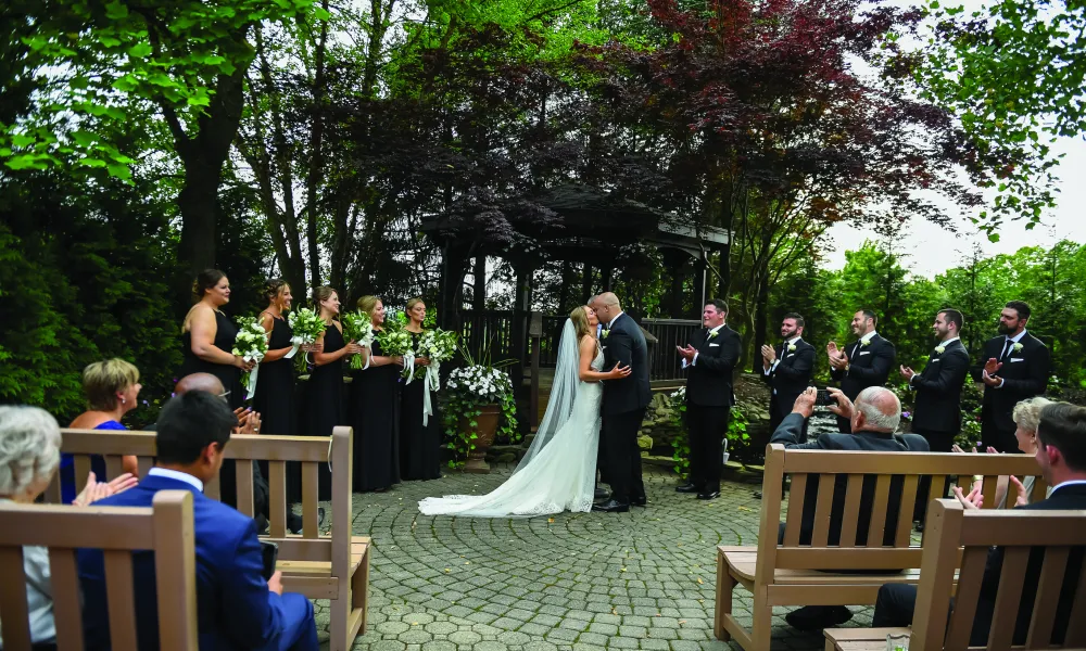 Bride and groom kissing during wedding ceremony