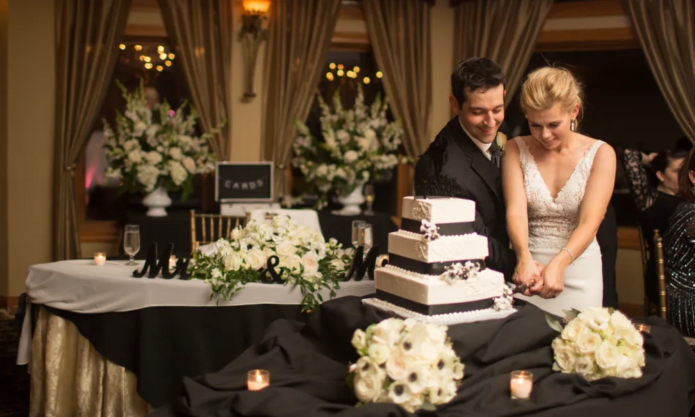 Bride and groom cutting wedding cake at Black Bear wedding reception