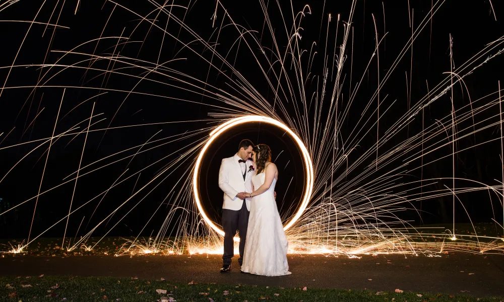 Bride and groom in the circle of sparklers