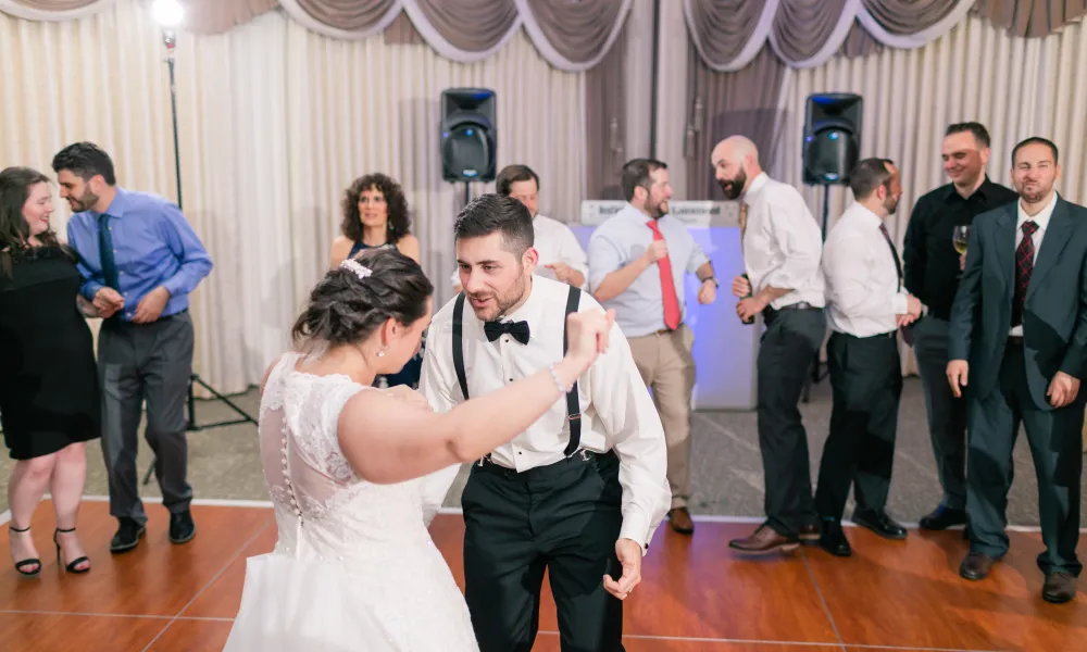 Bride and groom dancing with wedding guests