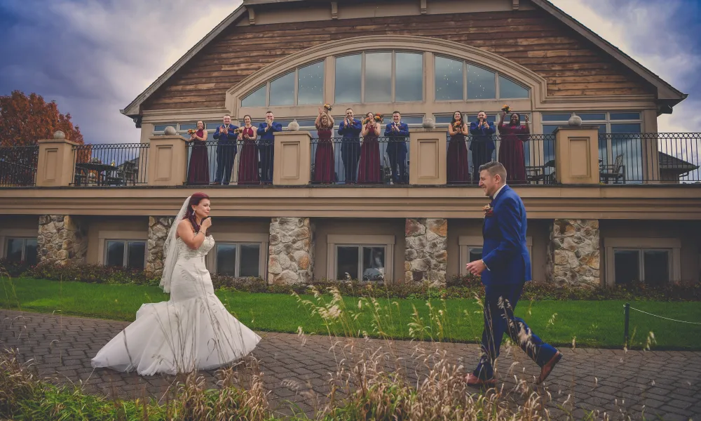 Wedding couple first reveal with wedding party watching from the Ballyowen balcony