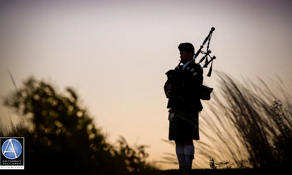 Silhouette of bagpiper playing