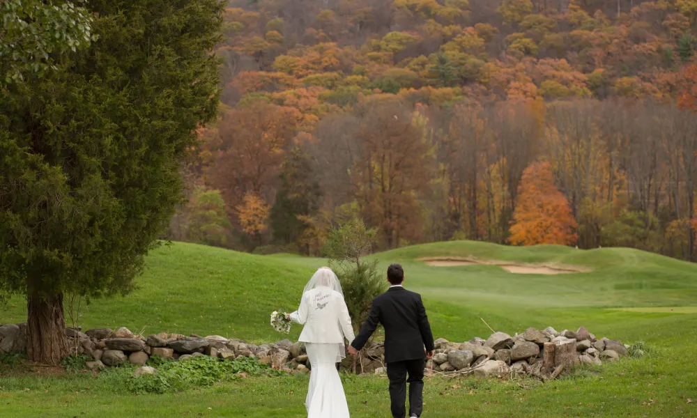 Bride and groom walking the grounds of Black Bear Golf Club