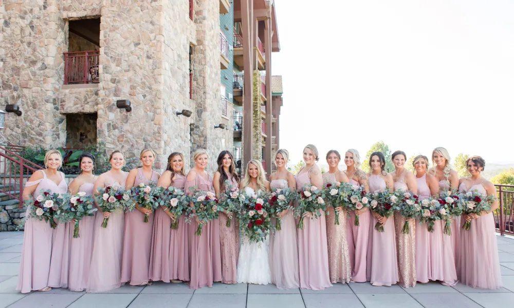 Bridesmaids in light pink dresses ready for wedding ceremony