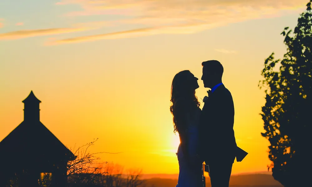 Wedding couple with a sunset on the golf course