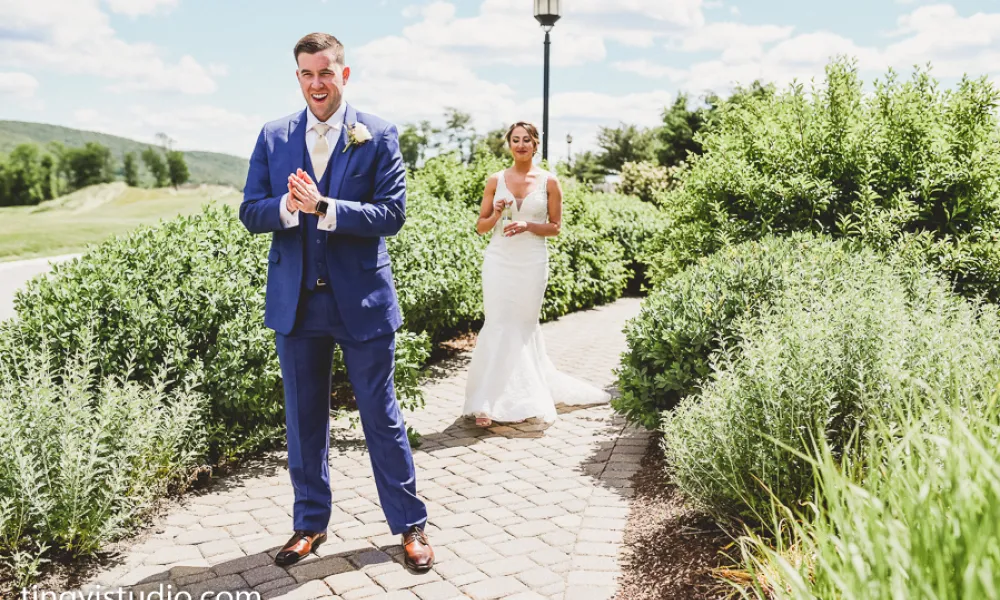 Bride and Groom first look on path in front of Grand Cascades Lodge