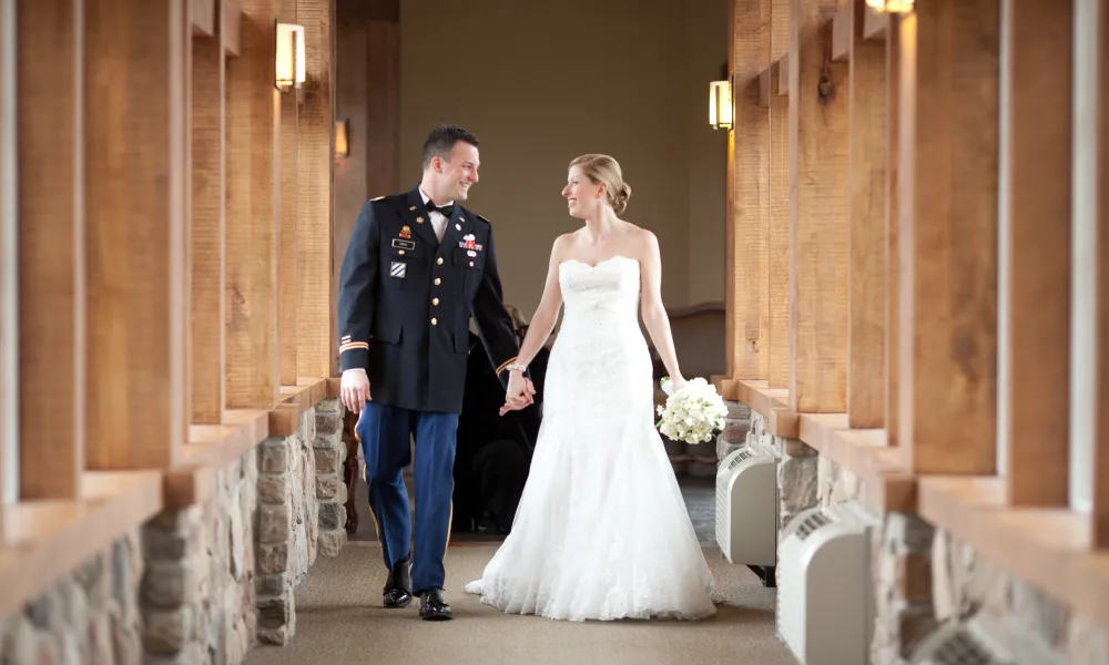 Bride and groom walking the halls of Grand Cascades Lodge