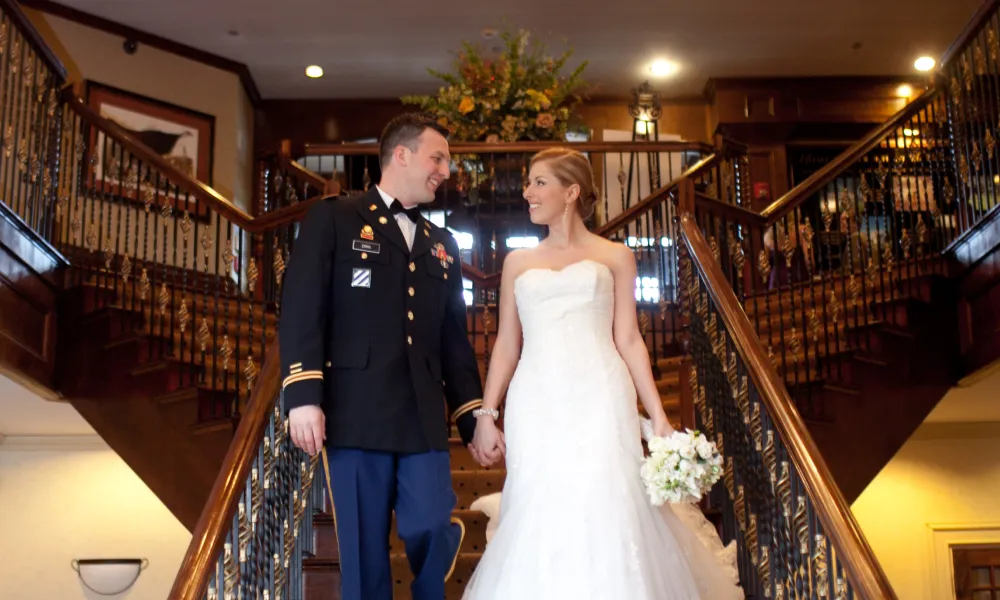 Wedding couple walking down stairs at Crystal Springs Clubhouse