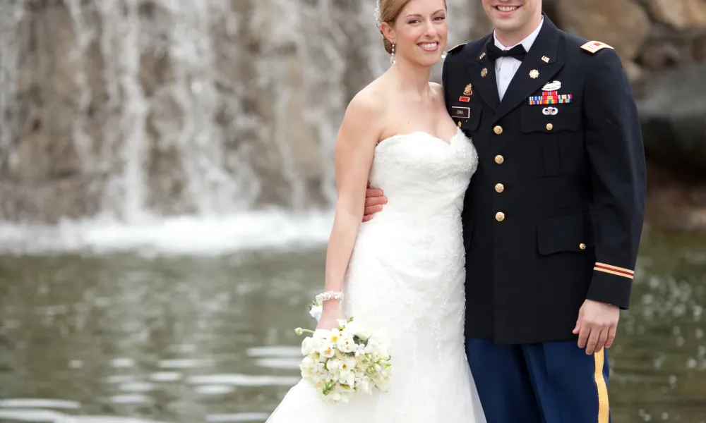 Bride and groom in front of waterfall