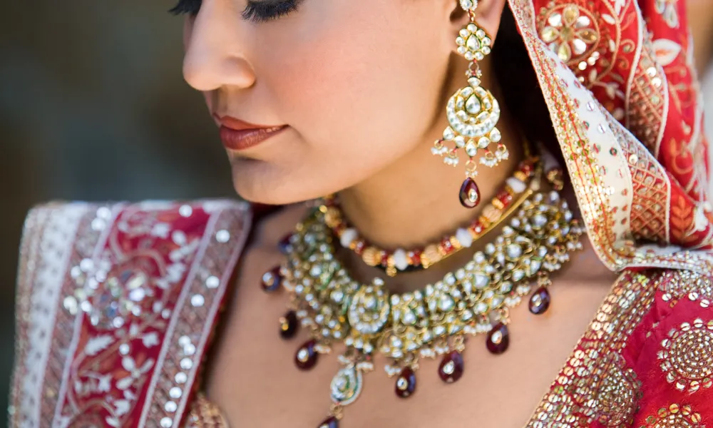 Indian bride dressed in a red and gold saree